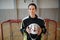 Close-up of woman floorball goalkeeper in helmet concetrating on game in gym.