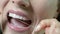 Close Up Of Woman Flossing White Teeth