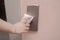 Close up of woman forefinger pressing the button in the elevator through a napkin,