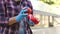 Close-up of woman gardener holding ripe tomato in greenhouse.