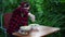 Close up of woman in glasses prepares salad outdoors. Female sprinkling grated cheese into plate.