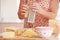 Close Up Of Woman Grating Cheese In Kitchen