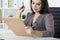 Close up of a woman in gray looking at clipboard