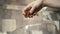 Close up of woman hand adding raisins into the dish. Action. Female hand holding dried fruits and putting it in a