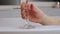 Close up of woman hand with cigarette taking bath with glass of wine.