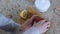 Close-up of woman hand closes the jar with slices of lemon with red lid.