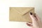 Close-up of woman hand holds brown kraft envelope