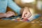 Close-up on woman hand playing puzzles at home. Connecting jigsaw puzzle pieces in a living room table, assembling a jigsaw puzzle