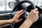 Close up of woman hand pressing the horn button while driving a