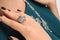 close-up woman hand with ring on finger and necklace on background