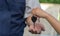 Close up of the woman hand is sending the car keys to the car mechanic. The concept of trust And confidence in using the service