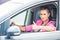 Close-up of a woman hand showing a thumbs-up sign out with car windows