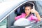 Close-up of a woman hand showing a thumbs-up sign out with car windows