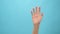 Close up of woman hand showing waving bye on the blue background