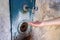 Close up of woman hand under running water from a fountain in the wall. Thirsty and water crisis concept