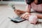 Close-Up of Woman Hand is Using Calculator for Calculated Accounting Money Saving or Expense Claim on Her Bedroom, Business