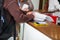 Close up of a woman hand writing or signing in a document on a reception zone of clinic. Selective focus