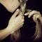 Close up woman hands braiding hair, sensual look