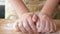 Close up of woman hands crumple dough