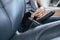 Close up of woman hands fastening or putting seat belt