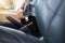 Close up of woman hands fastening or putting seat belt