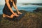 Close-up of woman hands folding black yoga mat before workout outdoors