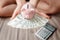 Close-Up Woman Hands is Holding Money Cash and Piggy Bank in Her Bedroom, Pink Piggy Saving, Business Banking and Financial