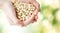 Close up of woman hands holding peeled peanuts