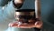 Close-up of woman hands holding and playing on small Tibetan Singing Bowl.