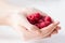 Close up of woman hands holding raspberries