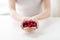 Close up of woman hands holding raspberries