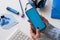 Close-up on woman hands holding smart phone with blue display. Blue color on accessories