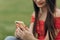 Close-up on woman hands holding smartphone in the center of the city. Woman using smart phone