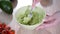 Close-up Of Woman Hands Mashing Avocado With Fork In Bowl