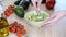 Close-up of woman hands mashing avocado with fork in bowl.