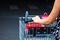 Close up of woman hands pushing empty shopping cart isolated in Bucharest, Romania, 2021