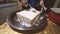 Close-up of woman hands putting cream on a sponge cake by hand using a spoon