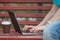 Close up of a woman hands typing in a laptop in park