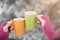 Close up of woman hands in woolen gloves holding a cup of coffee