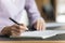 Close up of woman handwrite in notebook studying indoors