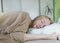 Close-up of a woman head on the wrong pillow. The formation of deep wrinkles on the face due to improper sleep. Skin deformation