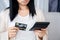 Close-up woman holding credit card and calculator having problem with overspending , overdue payment