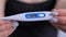 Close up: woman holding digital medical thermometer with high temperature