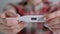 Close up: woman holding digital medical thermometer with high temperature