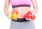 Close-up of woman holding dumbbells and fruits