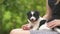 Close up of a woman holding small puppy on her lap.