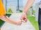 Close up of woman holds the hand of a lovely child.