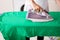 Close-up Of Woman Ironing Green T-shirt