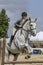 Close-up of woman jumping hunter gelding