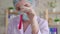 Close up of a woman laboratory assistant conducting a study of fluid in a test tube slow mo